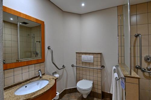 a bathroom with a sink and a toilet at Road Lodge Sandton in Johannesburg