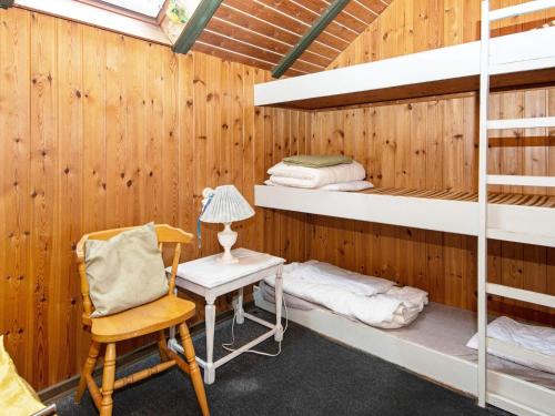 a room with bunk beds and a desk and a chair at 7 person holiday home in Toftlund-By Traum in Vestergård