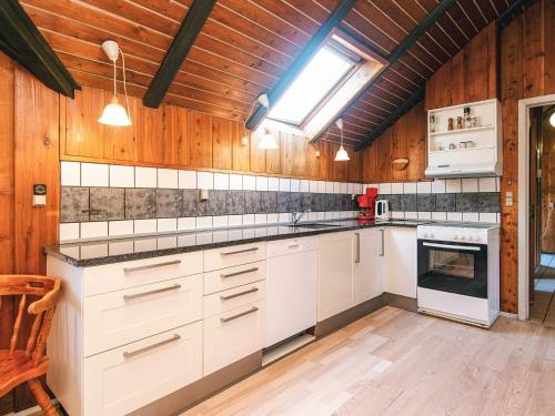 a kitchen with white cabinets and a skylight at 7 person holiday home in Toftlund-By Traum in Vestergård