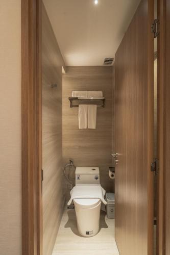 a bathroom with a toilet in a small room at Nola Hotel in Ho Chi Minh City