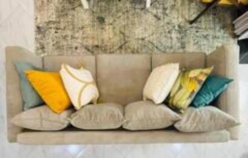 a couch with pillows on it in a room at BluBlush Fine Living in Kampala