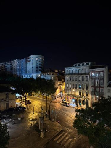 a city street at night with buildings and street lights at Inspira Santos Boutique Hotel in Lisbon