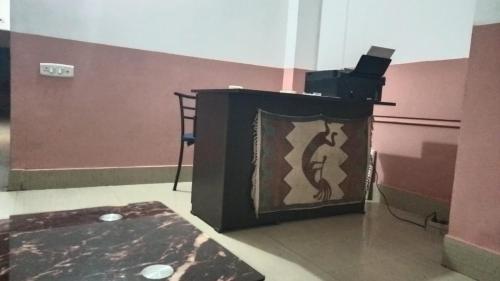 a black podium with a picture of a person on it at Hotel Suvika Inn in Guwahati