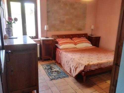 a bedroom with a bed and a window at Da Foschetta in Matelica