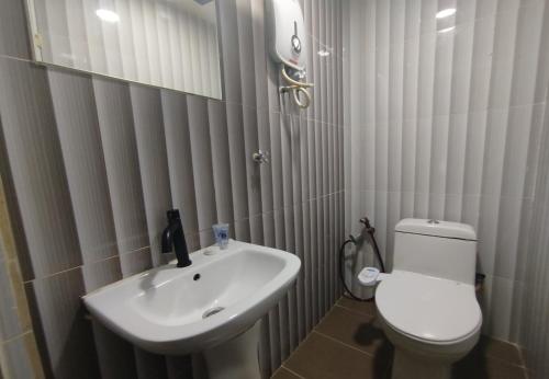a bathroom with a white toilet and a sink at Fast Hotel Idaman Near To IIUM KL in Kuala Lumpur