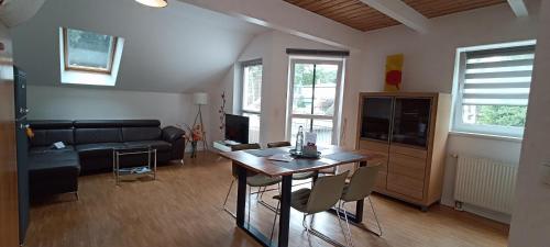 a living room with a table and a couch at Juliusruh Strandparadies 6 in Juliusruh