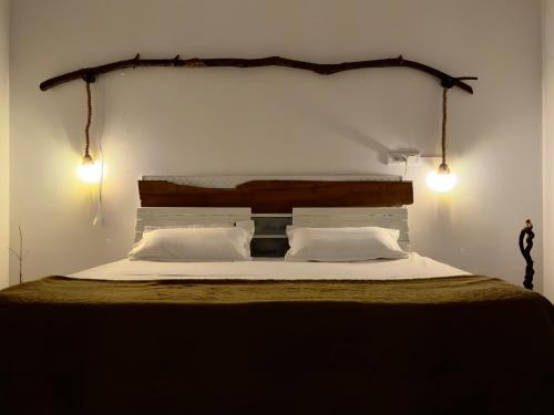 a bedroom with a bed with two lights on it at Private Farmhouse Villa Bir 15 Min From Paragliding in Chauntrā