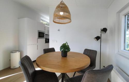 a dining room with a wooden table and chairs at Lovely Home In Heinkenszand With Heated Swimming Pool in Heinkensand
