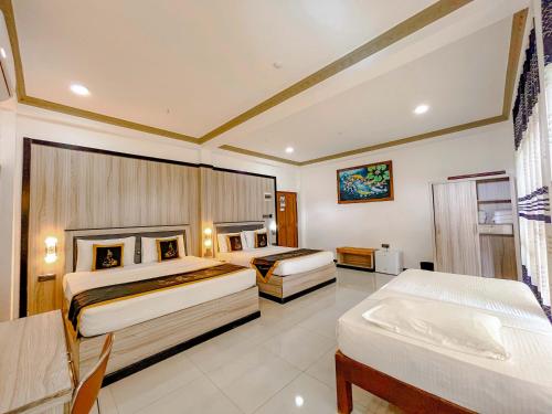 a hotel room with two beds in a room at Sigiriya Kingdom Resort in Dambulla