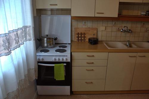 a small kitchen with a stove and a refrigerator at Aμvrosia Avramio Village - Fireplace, Free WiFi, Pet Friendly in Avramión