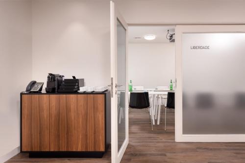 an office with a wooden cabinet and a conference room at Inspira Liberdade Boutique Hotel in Lisbon