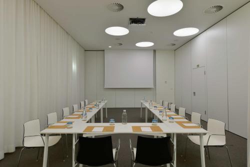 a conference room with a long table and chairs at Inspira Liberdade Boutique Hotel in Lisbon