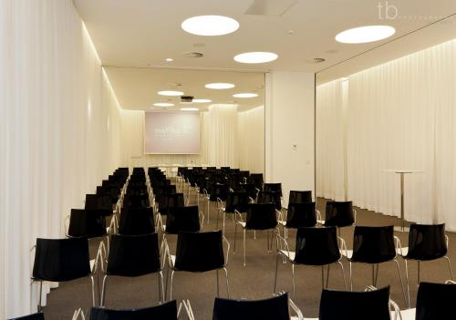 a conference room with chairs and a projection screen at Inspira Liberdade Boutique Hotel in Lisbon