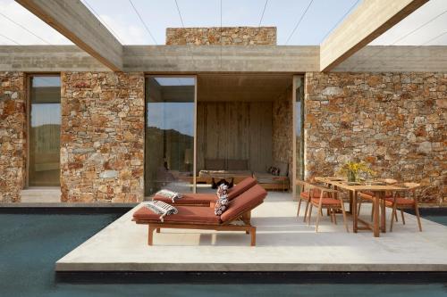 a living room with a couch and a table at Perma Serifos in Serifos Chora