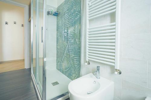 a bathroom with a sink and a glass shower at Sirio Guest House in Salerno