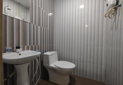 a bathroom with a white toilet and a sink at Fast Hotel Idaman Near To IIUM KL in Kuala Lumpur