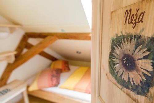 a room with bunk beds with a flower on the wall at Guest House Kraljev Hrib in Kamniška Bistrica