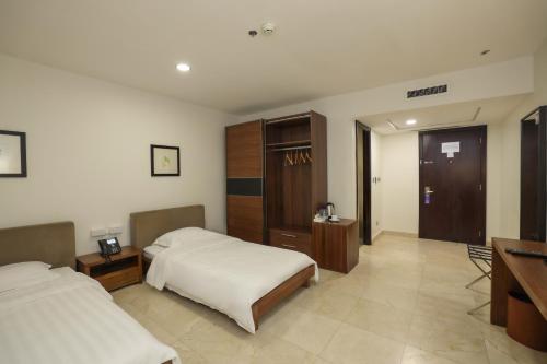 Ottoman Hotel Al Khobarにあるベッド