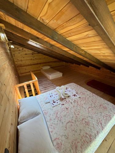 a bedroom with a bed in a wooden attic at Pallas Otel in Ardeşen