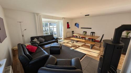 a living room with a couch and a table at am-hoeben in Fehmarn