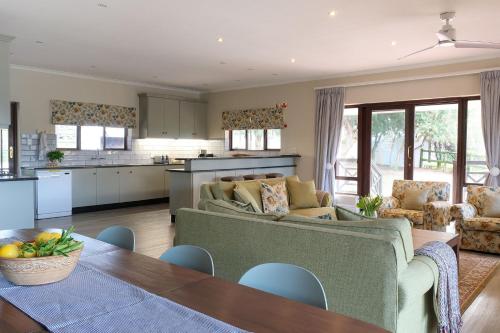 a living room with a couch and a table at High Season Farm Luxury Cottages in Hermanus