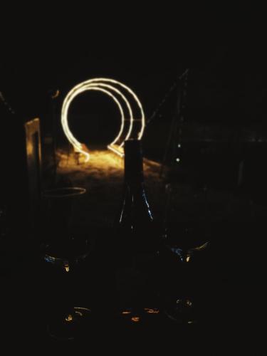 a close up of a wine bottle in the dark at PAMJA Guest House in Bărăşti