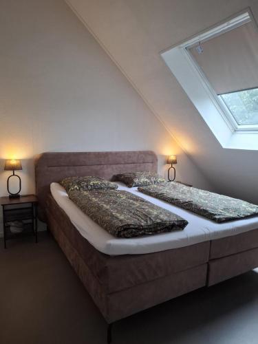a large bed in a room with a skylight at BonAparte in Hank