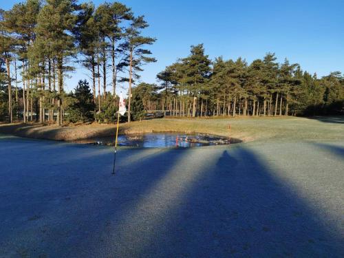 a shadow of a golf club on a golf course at Seaside Escape in Ho Bay - By Traum Ferienwohnungen in Ho