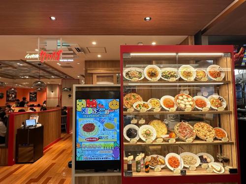 a display case of food in a restaurant at Y K Kyoto Nijo Traditional House close to Arashiyama in Kyoto