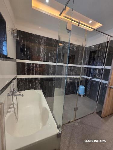 a bathroom with a glass shower and a sink at The Four Seasons Recreation in Jālgaon