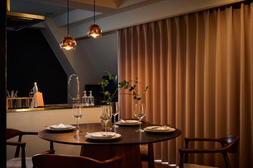 a dining room table with chairs and a curtain at R STAY Shiba in Tokyo