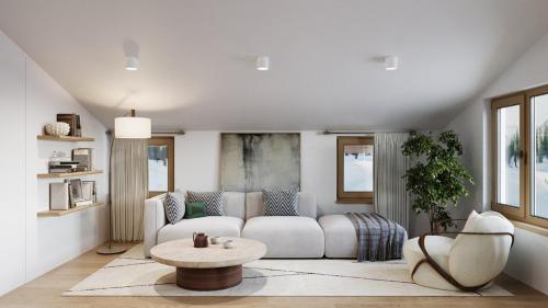 a living room with a white couch and a table at Zug503 Appartement in Lech am Arlberg in Lech am Arlberg