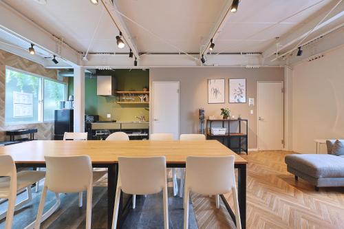 a dining room with a large table and chairs at Oneness House Tokyo 東京四ツ木 in Tokyo