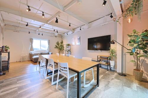 a dining room with a large table and chairs at Oneness House Tokyo 東京四ツ木 in Tokyo