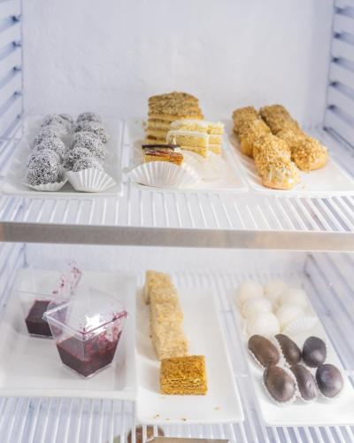a refrigerator filled with lots of different types of food at Grand Mildom Hotel in Almaty