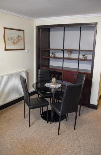 a dining room with a table and chairs and a window at Europa Gatwick Hotel & Spa in Crawley