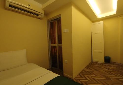 a small bedroom with a bed and a window at Fast Hotel Setapak Near Tunku Abdul Rahman UMT KL in Kuala Lumpur