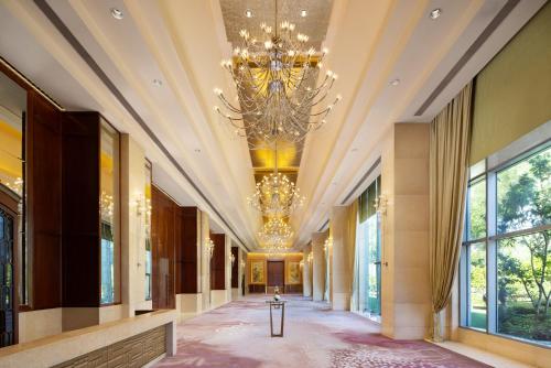 a hallway in a building with a chandelier at Shangri-La Wenzhou in Wenzhou