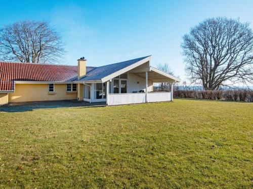 a house with a red roof and a grass field at Modern Retreat by Water - By Traum Ferienwohnungen in Egeskov