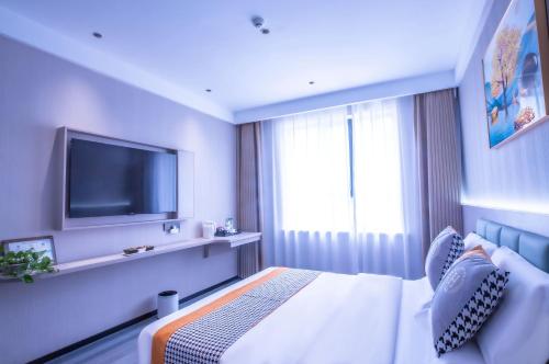 Postel nebo postele na pokoji v ubytování Xingang International Hotel