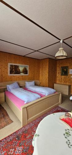 a bedroom with two beds in a room at Alphenrose saxeten in Saxeten