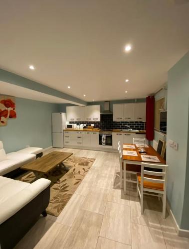 a kitchen with a couch and a table in a room at Spacious 3-Bedroom Family Home in Oxford in Oxford