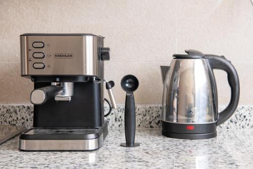 a coffee maker on a counter next to a tea kettle at TT Holidays Centro in Rabat