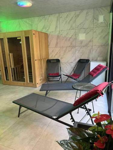 a room with two chairs and a table in a room at Maisonnette privatisée in Sedan