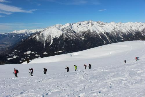 a group of people skiing down a snow covered mountain at Casa Danoli in Canale San Bovo