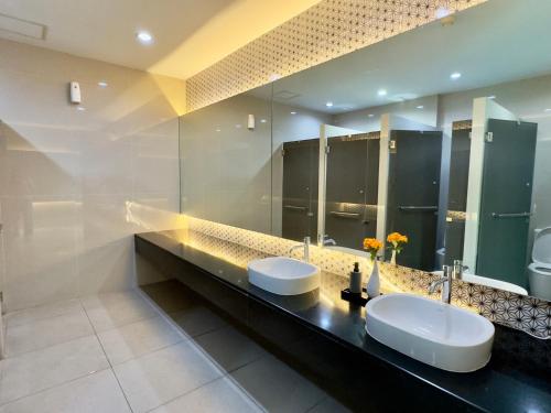 a bathroom with two sinks and two mirrors at Condo is next to the mall Big swimming pool 2 in Chiang Mai