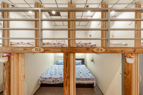 a bunk bed in a room with two beds at Sun Moon Lake Jinlongshan BnB in Yuchi