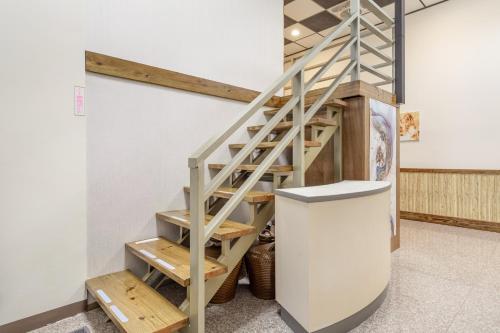 a wooden staircase in a room next to a wall at Sun Moon Lake Jinlongshan BnB in Yuchi
