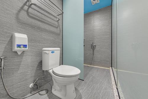 a bathroom with a toilet and a shower at Sun Moon Lake Jinlongshan BnB in Yuchi