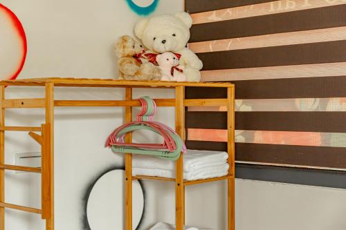 a bunk bed with two teddy bears on a shelf at Sun Moon Lake Jinlongshan BnB in Yuchi